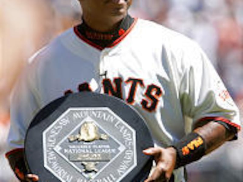 San Francisco's Barry Bonds holds up the NL MVP award during a pregame ceremony Tuesday.