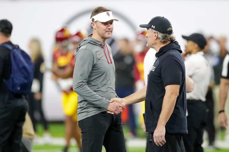 Utah Utes head coach Kyle Whittingham and USC Trojans head coach Lincoln Riley shake hands before the Pac-12 championship at the Allegiant Stadium in Las Vegas on Friday, Dec. 2, 2022.