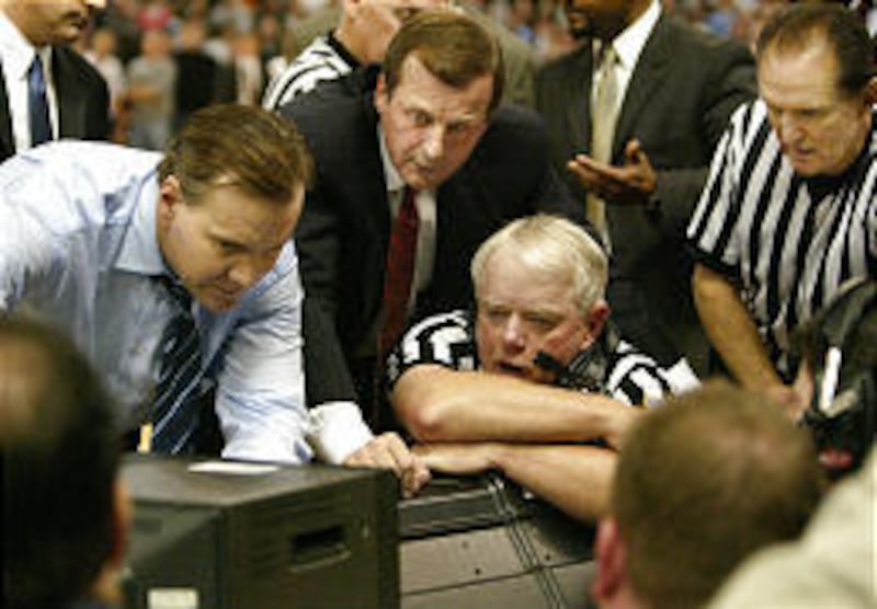 Providence coach Tim Welsh, left, and Texas' Rick Barnes join officials in video review of game-winning play.