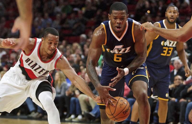 Portland Trail Blazers guard C.J. McCollum, left, strips the ball away from Utah Jazz forward Joe Johnson during the first half of an NBA preseason basketball game in Portland, Ore., Monday, Oct. 3, 2016. (AP Photo/Craig Mitchelldyer)