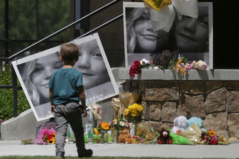 A boy looks at a memorial for Tylee Ryan and Joshua “JJ” Vallow in Rexburg, Idaho, on June 11, 2020.