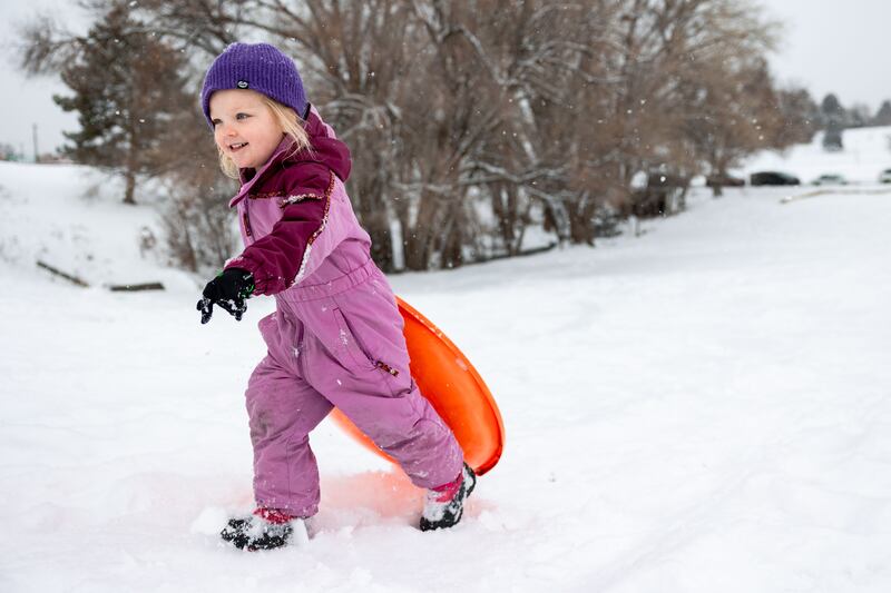 Grace, 3, walks her sled back up a hill at Sugar House Park in Salt Lake City on Sunday, Jan. 7, 2024.