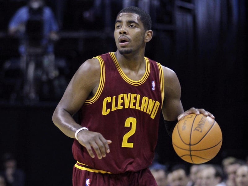 In this April 23, 2012, photo, Cleveland Cavaliers' Kyrie Irving brings the ball up during NBA basketball game against the Memphis Grizzlies in Memphis, Tenn. Irving broke his right hand during a practice in Las Vegas and could be sidelined for two months
