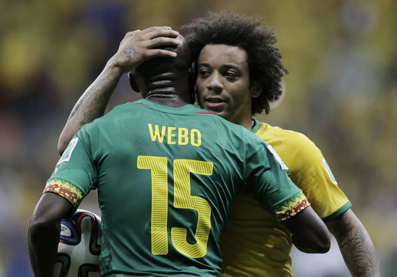 Brazil's Marcelo hugs Cameroon's Pierre Webo following Brazil's 4-1 victory over Cameroon in the group A World Cup soccer match between Cameroon and Brazil at the Estadio Nacional in Brasilia, Brazil, Monday, June 23, 2014. (AP Photo/Bernat Armangue)