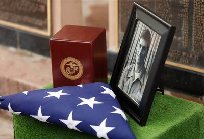 The American flag is placed next to the ashes and a photo of former Vietnam War POW Richard Burgess at the end of services at Camp Williams in Bluffdale on Friday, July 26, 2019. Burgess died on May 8 in his hometown of Gunnison.