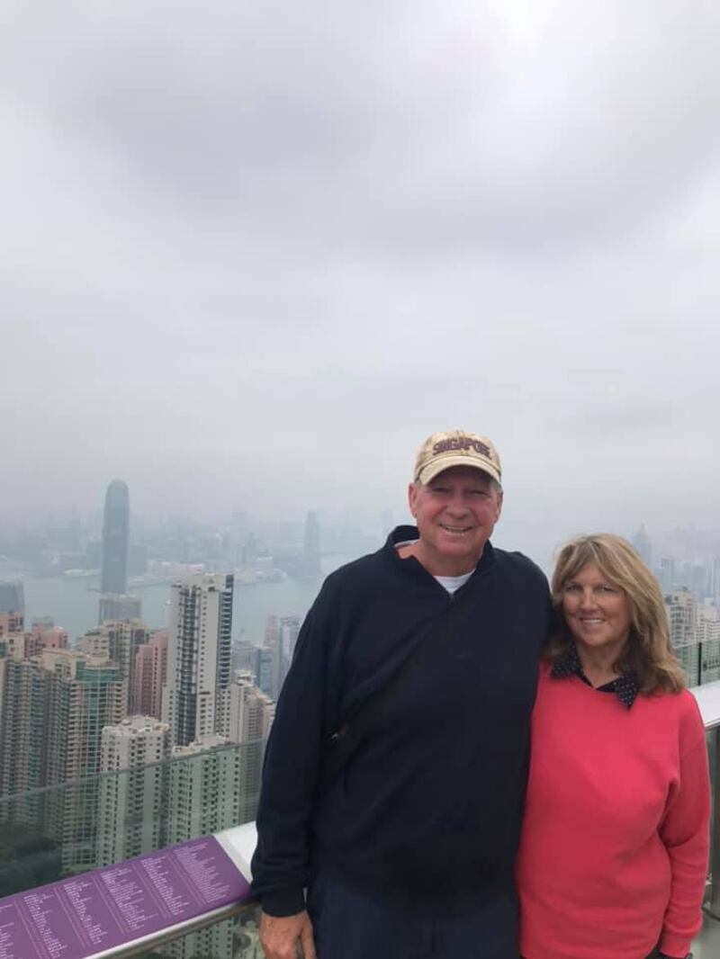 John and Melanie Haering pose for a photo in Hong Kong. The couple is traveling aboard a cruise ship that has been quarantined in Japan due to exposure to the novel coronavirus.