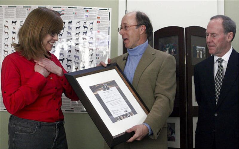 Holly Sizemore receives Ambassador of Caring award from Rod Ross and Larry Thomas.