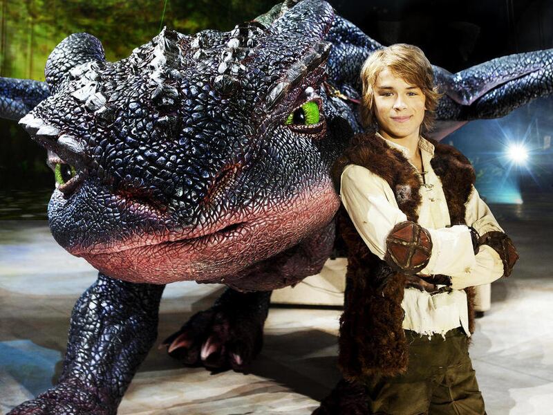 In this undated image released by DreamWorks Animation, actor Rarmian Newton, portraying the character Hiccup, poses with Toothless the dragon from "How to Train Your Dragon Live Spectacular." The production will launch their North American tour on June