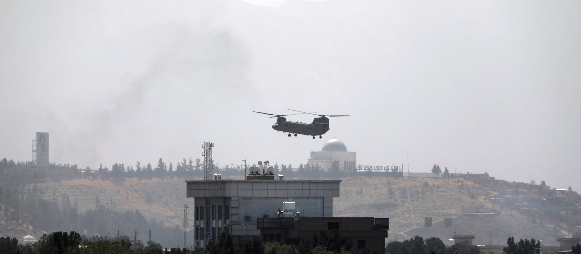 A U.S. Chinook helicopter flies over the U.S. Embassy in Kabul, Afghanistan, on Sunday, Aug. 15, 2021