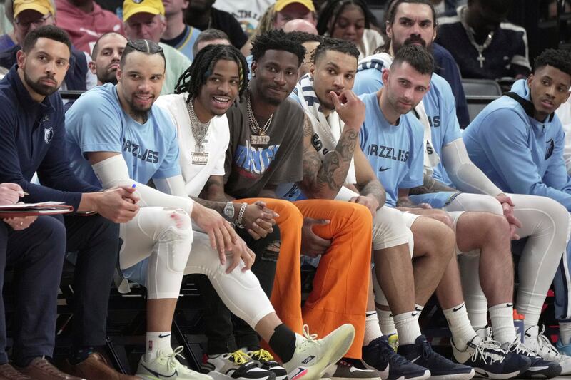 Memphis Grizzlies’ Ja Morant, third from left, looks on with teammates from the bench during game vs. Golden State Warriors.