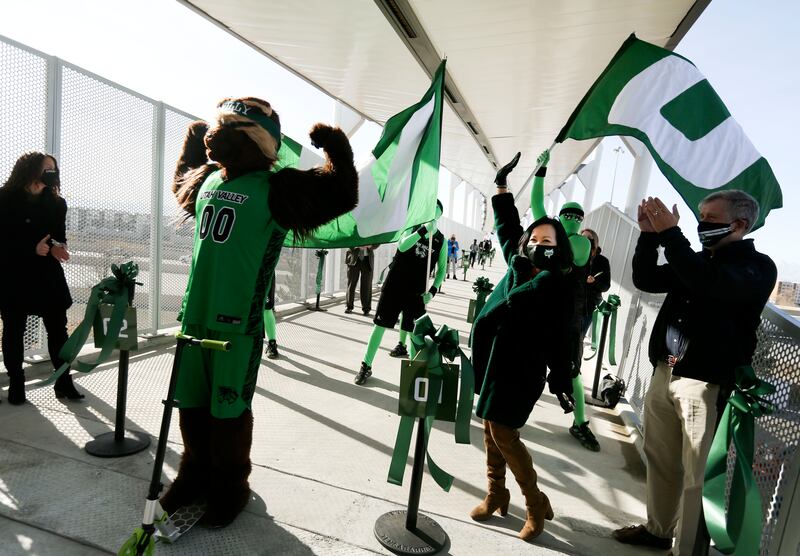 Utah Valley mascot Willy the Wolverine, left, President Astrid Tuminez and others celebrate a new pedestrian bridge connecting UVU with the UTA’s FrontRunner station.
