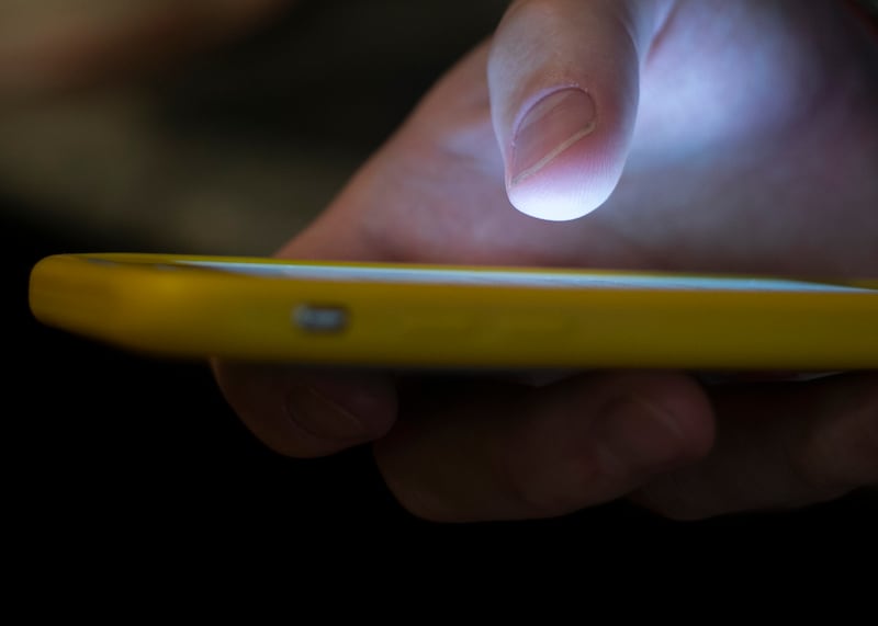 A man uses a cellphone in New Orleans.