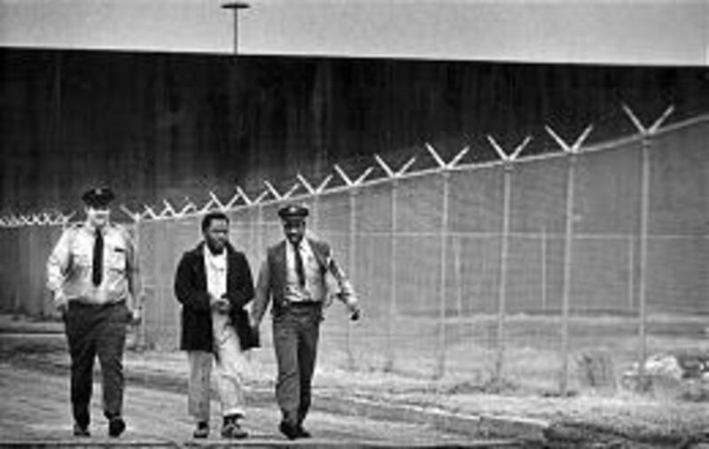 Kevin Hughes, who murdered a girl when he was 16, walks with Pennsylvania prison guards in 1988. He will now move off death row.