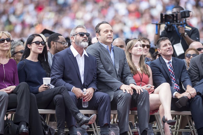 Actors Mel Gibson and Vince Vaughn look on during Liberty University's graduation on Saturday, May 14, 2016 in Lynchburg, Va (Jay Westcott/News & Daily Advance via AP) MANDATORY CREDIT