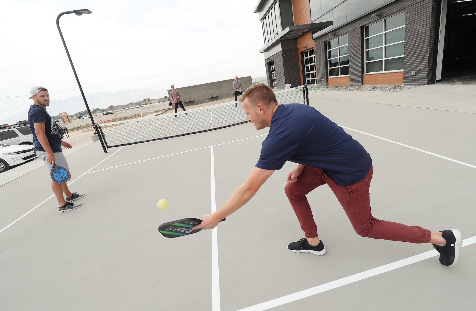 Regan Bushman hits the ball to a co-worker during a game of pickleball at Podium in Lehi.