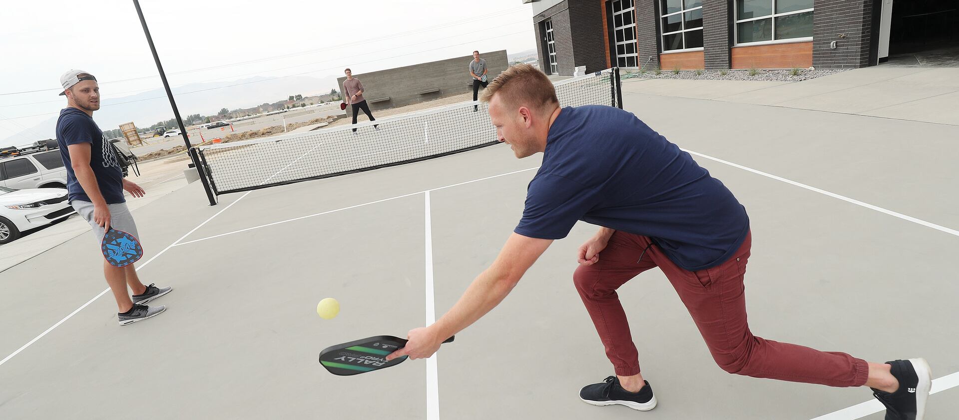 Regan Bushman hits the ball to a co-worker during a game of pickleball at Podium in Lehi.