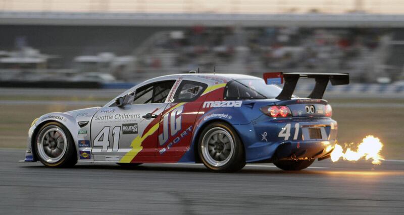 FILE - In this Jan. 29, 2011 file photo, flames shoot out of the exhaust of the Dempsey Racing Mazda RX-8 heading into the West Horseshoe turn during the Grand Am Rolex 24 Hours auto race at Daytona International Speedway in Daytona Beach, Fla. Mazda will