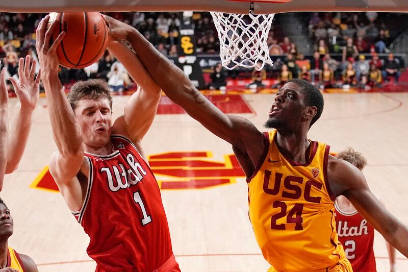 Utah forward Ben Carlson, left, grabs a rebound away from Southern California forward Joshua Morgan during the second half of an NCAA college basketball game Thursday, Feb. 15, 2024, in Los Angeles.