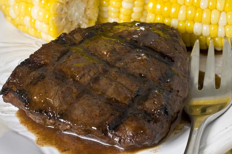 Steak is pictured with corn.