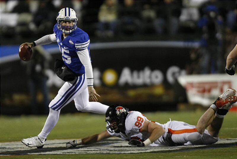 BYU quarterback Max Hall, shown avoiding a sack attempt by Oregon State's Gabe Miller in Tuesday night's Las Vegas Bowl, earned MVP honors in his final game as a Cougar.