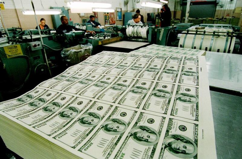 In this March 21, 1996 file photo, stacks of $100 bills await the printing of their serial numbers, at the Bureau of Engraving and Printing in Washington.