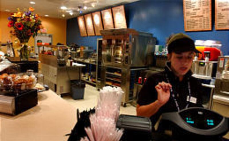 Caroline Stoltzfus operates the cash register at Auntie Anne's Cafe in Lancaster, Pa. The company is now testing whether the secret dough will sell pizzas and more.