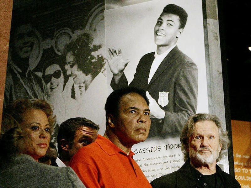 FILE - In this Nov. 18, 2005 file photo, boxing great Muhammad Ali is accompanied by his wife Lonnie and singer Kris Kristofferson as he tours the Muhammad Ali Center in Louisville, Ky. The man who became the world's most recognizable athlete was a baby