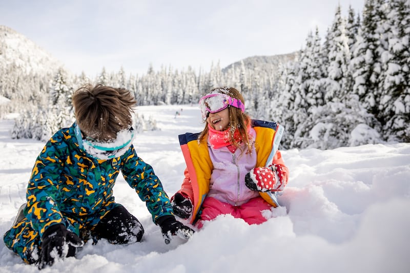 Derek Tima, 5, and Alina Mardirosian, 4, get a taste for fresh Utah powder after dunking their heads in the snow while sledding in Big Cottonwood Canyon on Jan. 4, 2023.