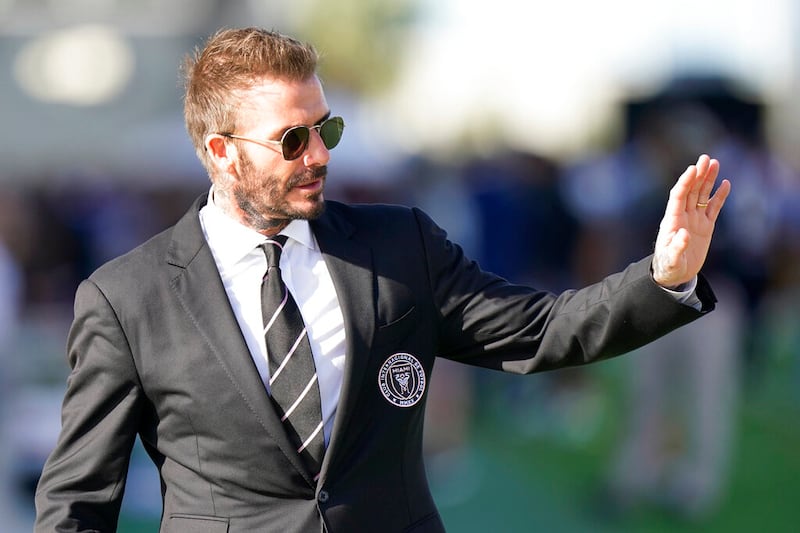 David Beckham waves to fans.