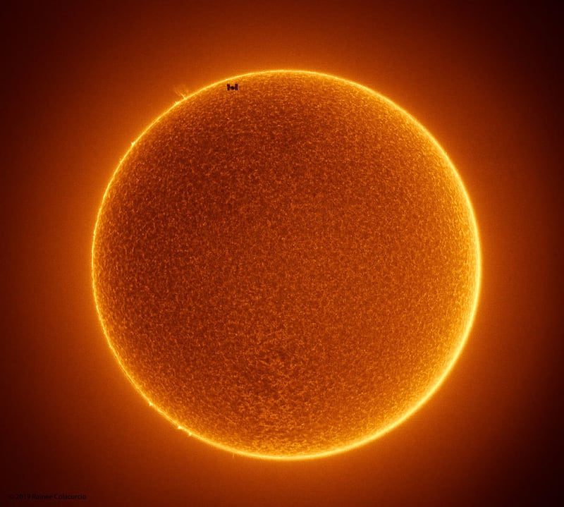 The photo meshes two photos together, one of the space station transiting the sun and another capturing the details of the sun’s actual surface.