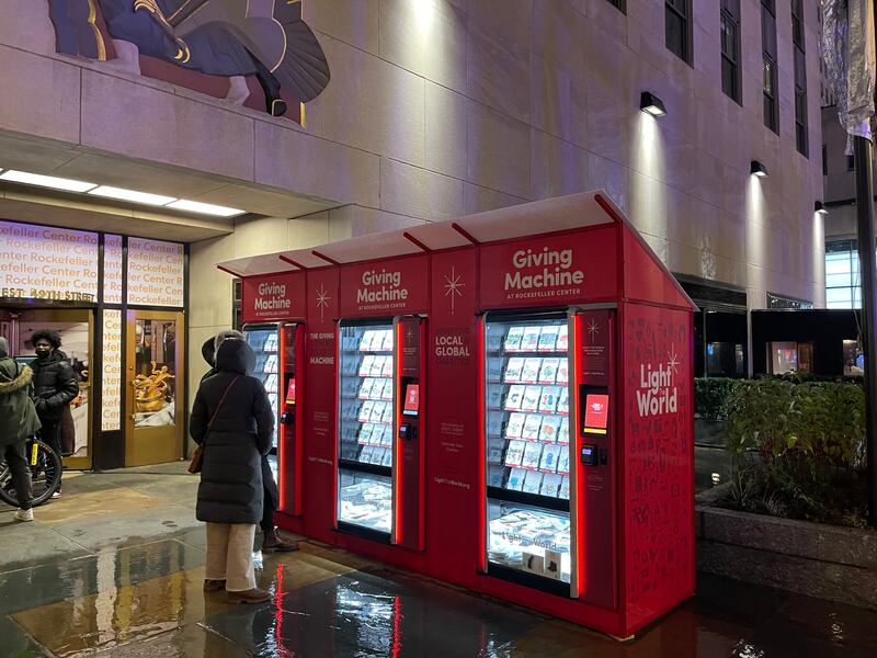 The church’s Giving Machines across the street from the Rockefeller Center’s Christmas tree and ice rink on Dec. 8, 2021.