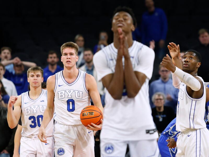 BYU’s Dallin Hall, left, and Rudi Williams, right, look on as Jaxson Robinson prepares to take a free throw vs. Creighton.