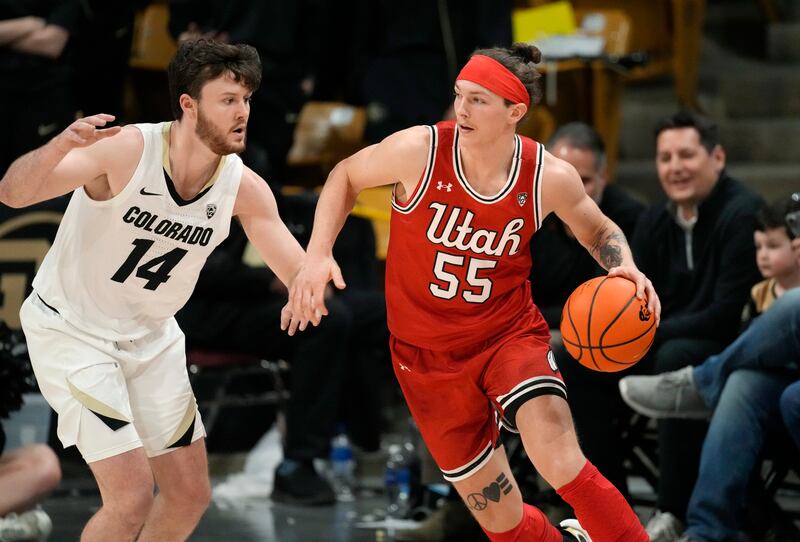 Utah guard Gabe Madsen, right, drives to the rim as Colorado guard Ethan Wright defends in the second half of an NCAA college basketball game, Saturday, March 4, 2023, in Boulder, Colo.