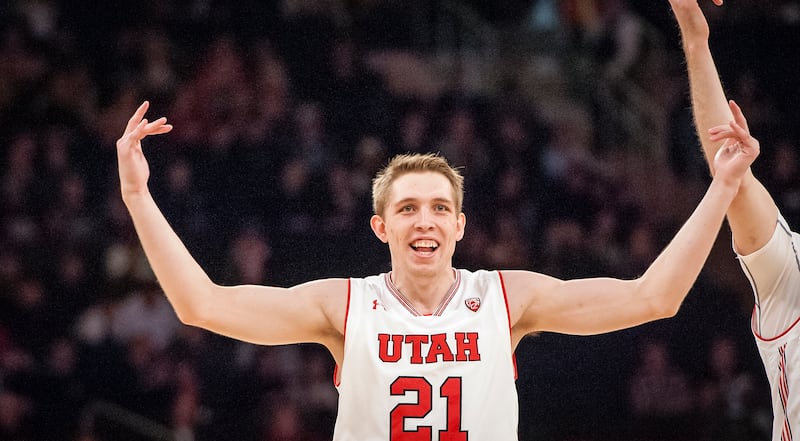 Utah forward Tyler Rawson raises his arms in celebration after tying the game in the first half with a 3-pointer during the Utes' NIT seminfinal game against Western Kentucky at Madison Square Garden in New York City on Tuesday, March 27, 2018.