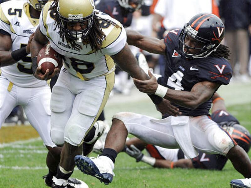 Georgia Tech's Anthony Allen gets yardage as Virginia's Vic Hall (4) tries to stop him during the first half of an NCAA college football game at Scott Stadium in Charlottesville, Va., on Saturday.