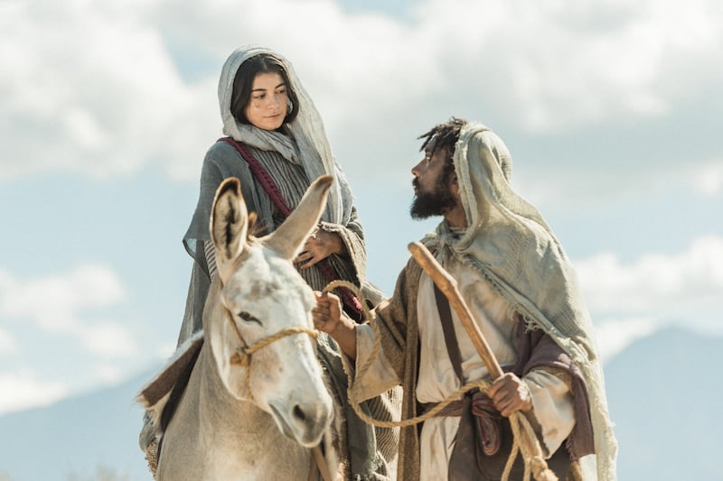 Joseph, played by Raja Bond, leads a donkey carrying Mary, played by Sara Anne, in “Christmas With The Chosen: The Messengers.”