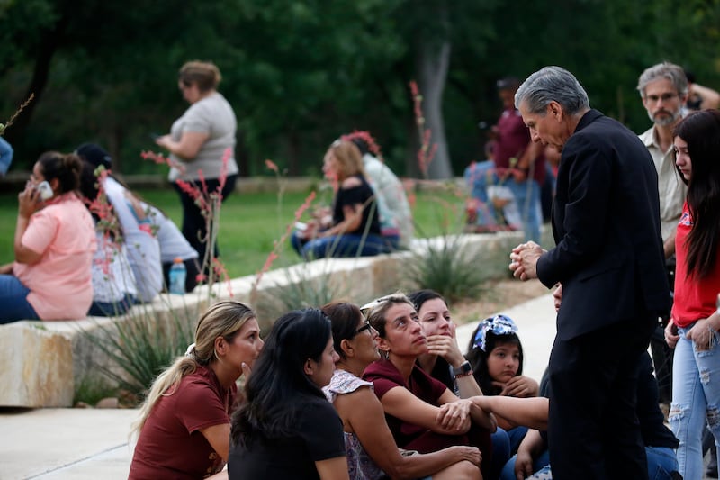 The archbishop of San Antonio, the Rev. Gustavo Garcia-Siller comforts families in Uvalde, Texas, Tuesday, May 24, 2022.