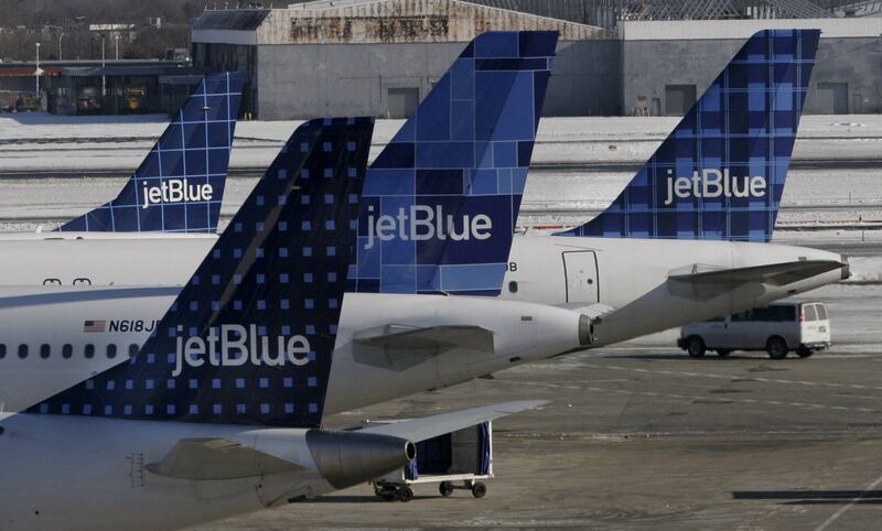 JetBlue planes wait at terminal gates at JFK Airport in New York in this Feb. 16, 2007, file photo.