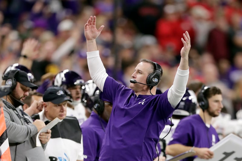 Northwestern head coach Pat Fitzgerald raises his arms on the sideline during the second half of the Big Ten championship NCAA college football game against Ohio State, Saturday, Dec. 1, 2018, in Indianapolis. (AP Photo/Michael Conroy)