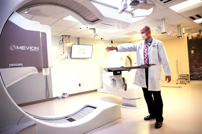 Dr. Bill Salter, senior director of radiation oncology at the Huntsman Cancer Institute, gives a tour of the treatment room.