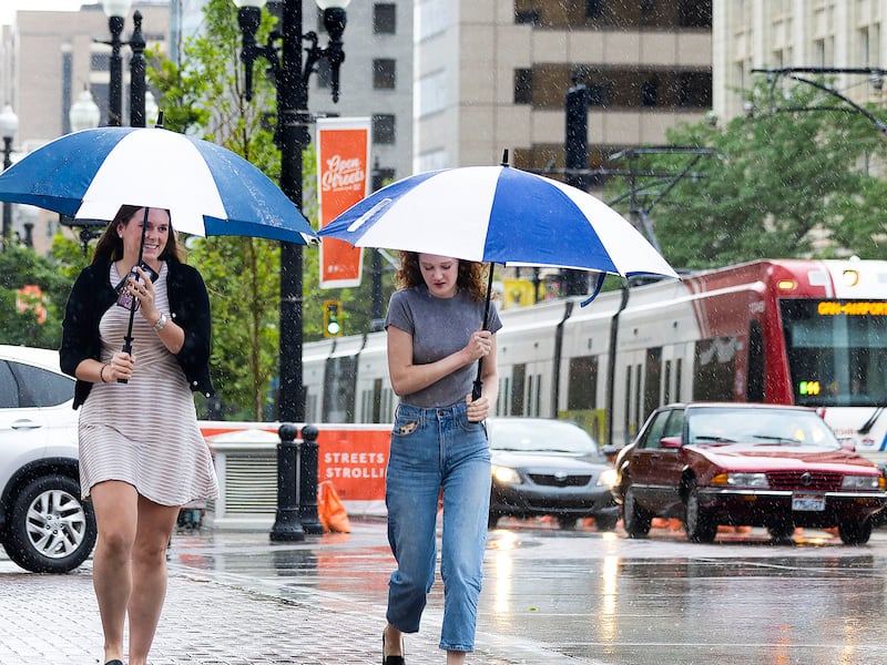 Alexandra Callaway and Deanna Upchurch walk in the rain in downtown Salt Lake City on Friday, July 15, 2022.