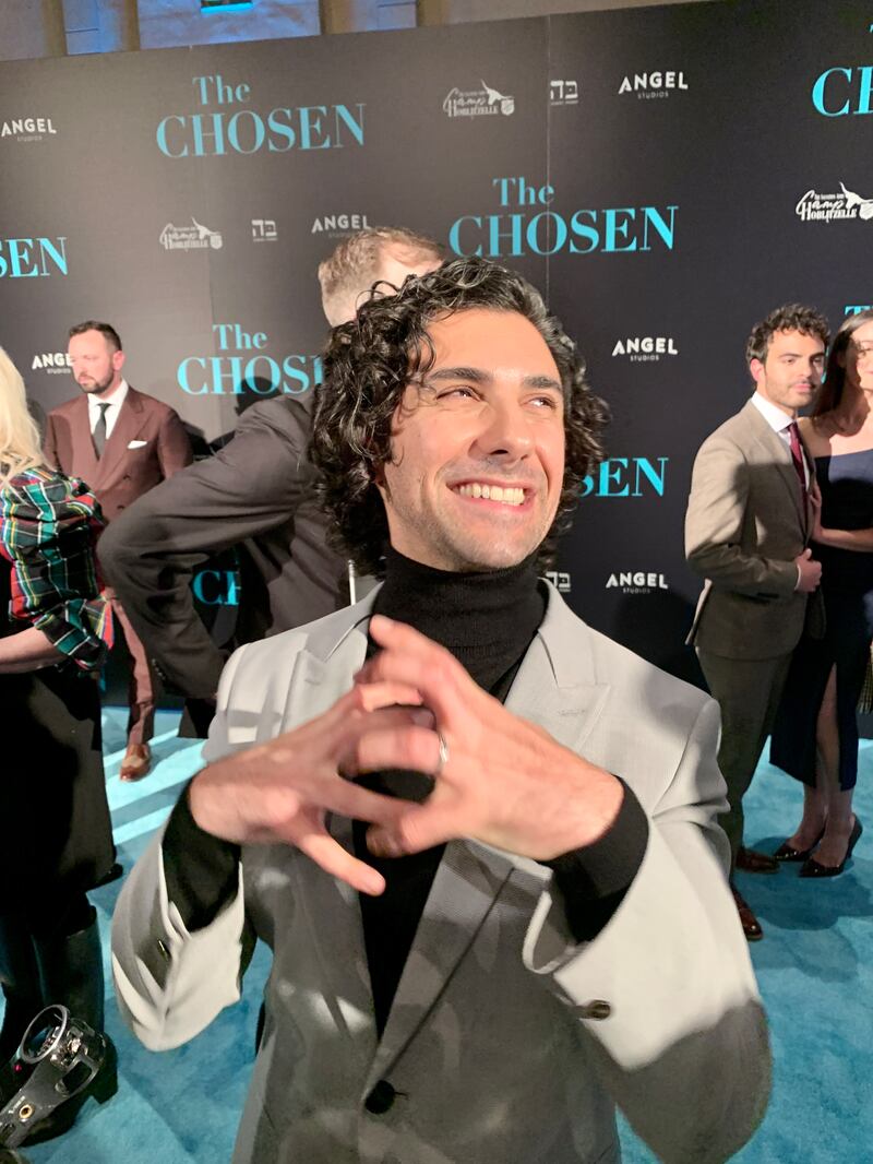 Noah James, who plays Andrew in “The Chosen,” speaks with news media on the “teal” carpet at the premiere of episodes 1-2 of Season 3.