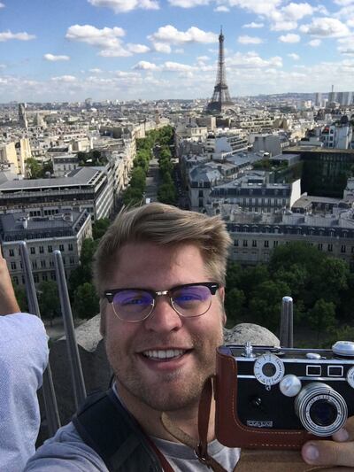 Taylor Dahl takes a selfie with his Argus C3 in front of the Eiffel Tower. While recreating his grandfather's photos, Dahl wanted to be as authentic as possible, so he bought the same model camera his grandfather had.