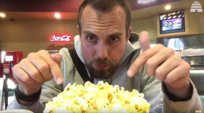 Herb Scribner prepares for the 'Toy Story 4' marathon by pointing at his popcorn.