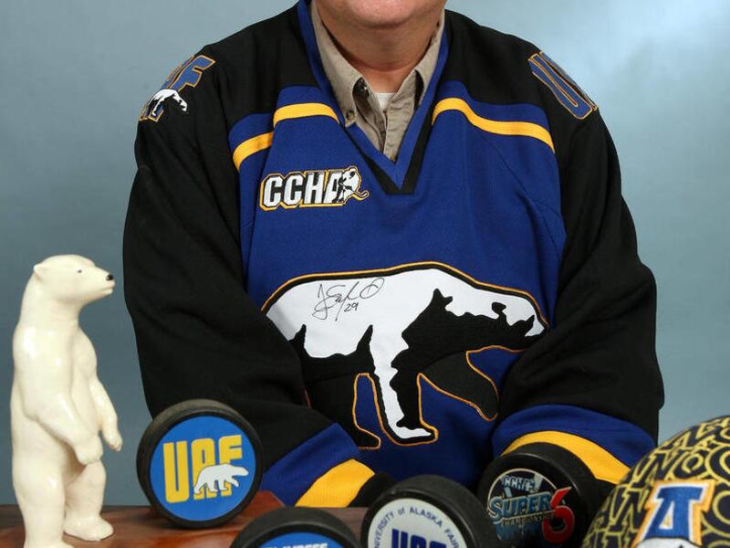 The voice of University of Alaska Fairbanks Division I Nanook hockey Bruce Cech poses with some of his memorabilia from 25 years of radio broadcasting the games on Dec.30, 2011 in Fairbanks. Alaska. Cech has called more than 800 Nanooks hockey games duri