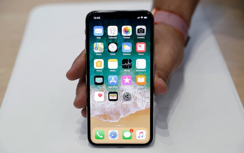 The new iPhone X is displayed in the showroom after the new product announcement at the Steve Jobs Theater on the new Apple campus on Tuesday, Sept. 12, 2017, in Cupertino, Calif. (AP Photo/Marcio Jose Sanchez)