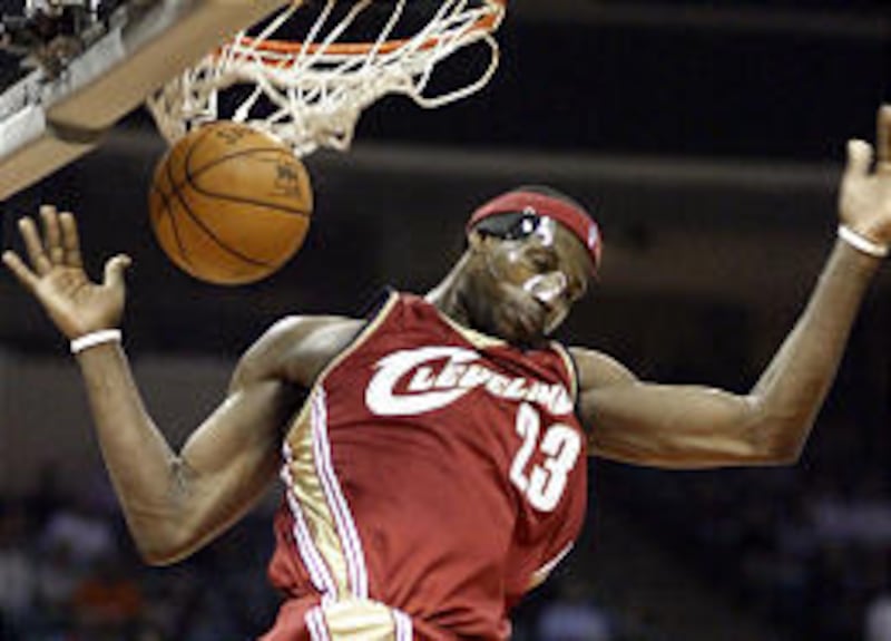 Cleveland Cavaliers' LeBron James dunks in their game against the Charlotte Bobcats on Monday. James is playing with a mask to protect his broken left cheek.