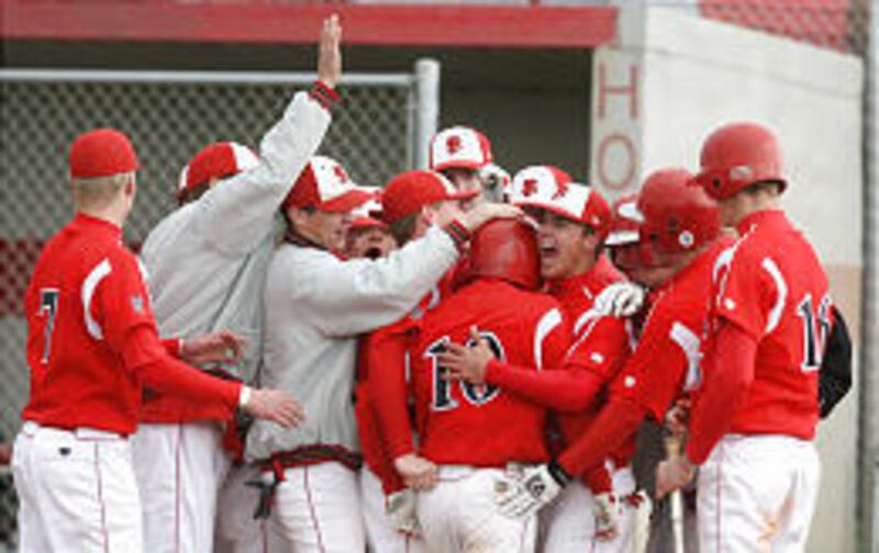 Spanish Fork's Cory Grover is met at home plate by his teammates after hitting a solo home run. He had two other hits plus five RBIs.