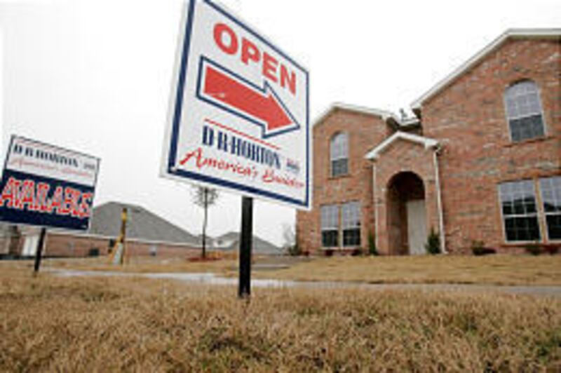 Signs welcome would-be buyers to a newly completed home in the Kingston Meadows development in Glenn Heights, Texas.
