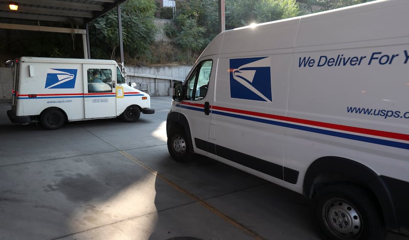 U.S. Postal Service letter carriers leave the post office in the Sugar House neighborhood of Salt Lake City on Oct. 7, 2020.